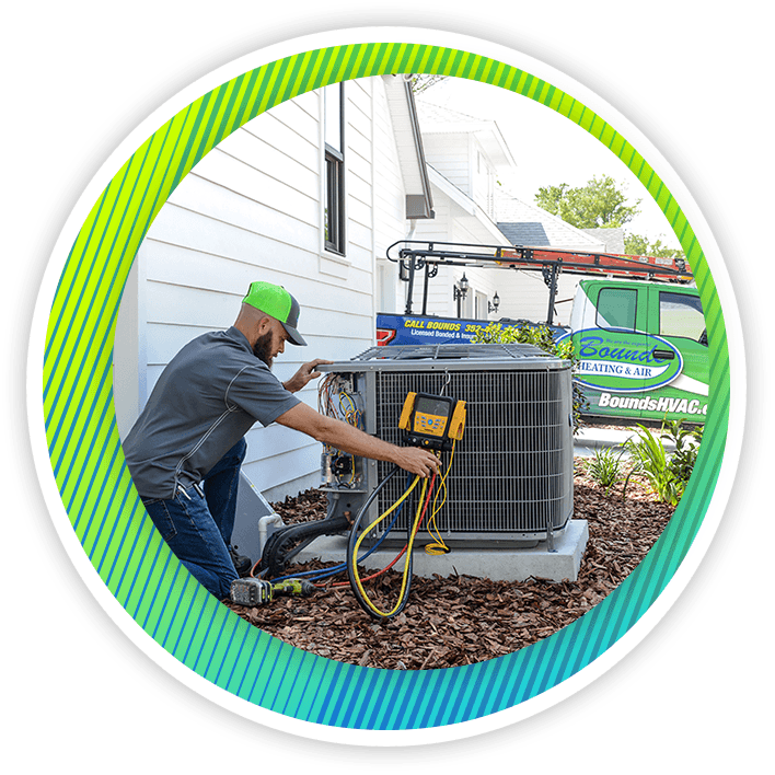 A technician performing an HVAC repair. | Air Conditioning Services