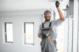 HVAC Technician Worker Testing Newly Installed Ventilation System